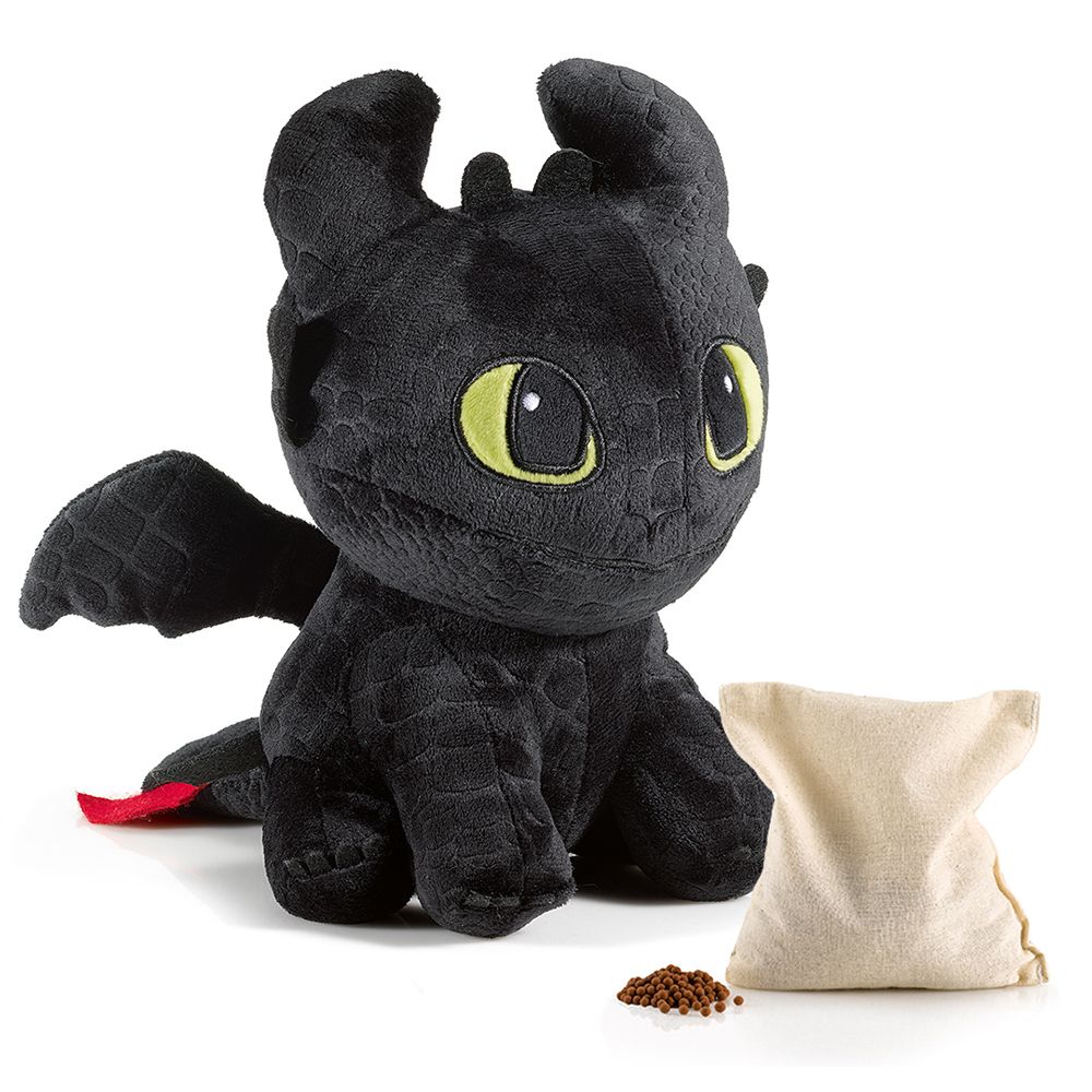 Dragon noir en peluche avec un sac et des granulés.