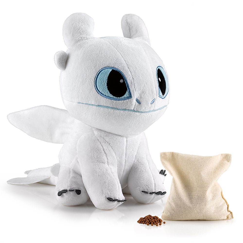 Dragon en peluche blanc aux yeux bleus, avec un petit sac.