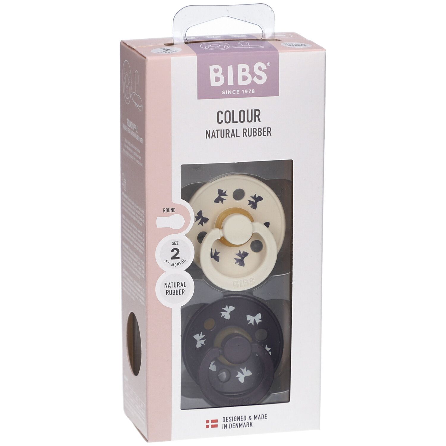 Emballage de deux sucettes. Visibles: sucette crème et bleu foncé avec motifs. Marque BIBS.