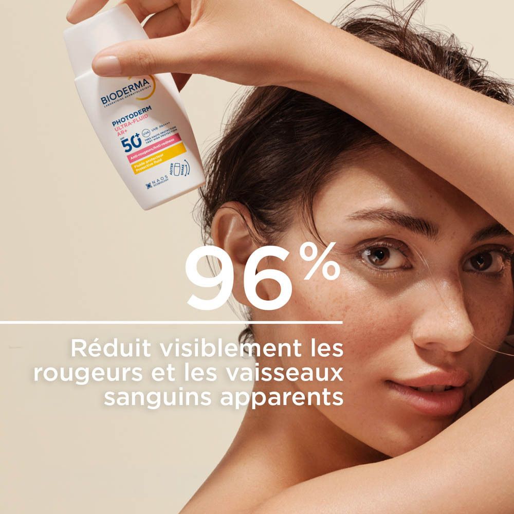 Produit et liquide. Flacon blanc avec liquide. Inscription: Bioderma, Photoderm Ultra-Fluid AR+, SPF 50+.