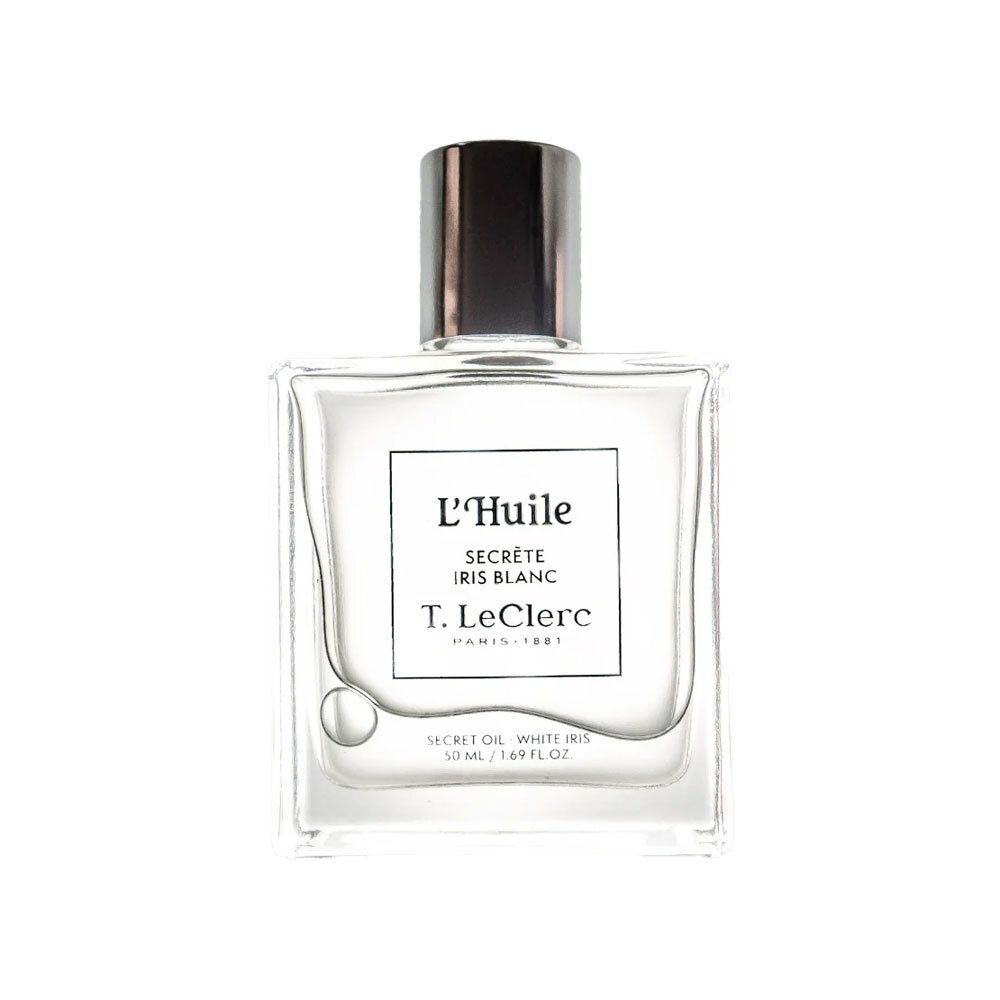 Flacon carré en verre avec bouchon argenté. Étiquette avec texte : L'Huile Secrète Iris Blanc, T. LeClerc. Contenu clair visible.