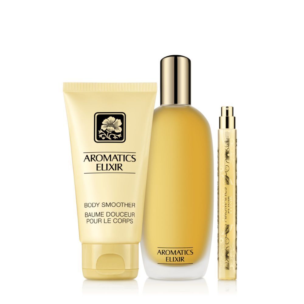 Trois produits Clinique Aromatic Elixir : baume corps, flacon parfum et vaporisateur. Crème et or.