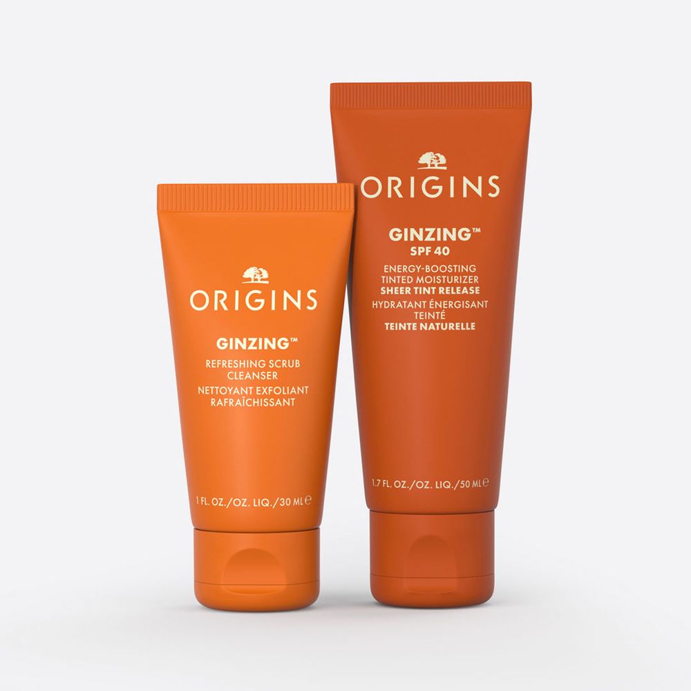 Deux tubes oranges avec les inscriptions "ORIGINS" et "GINZING". Un tube est plus petit que l'autre.