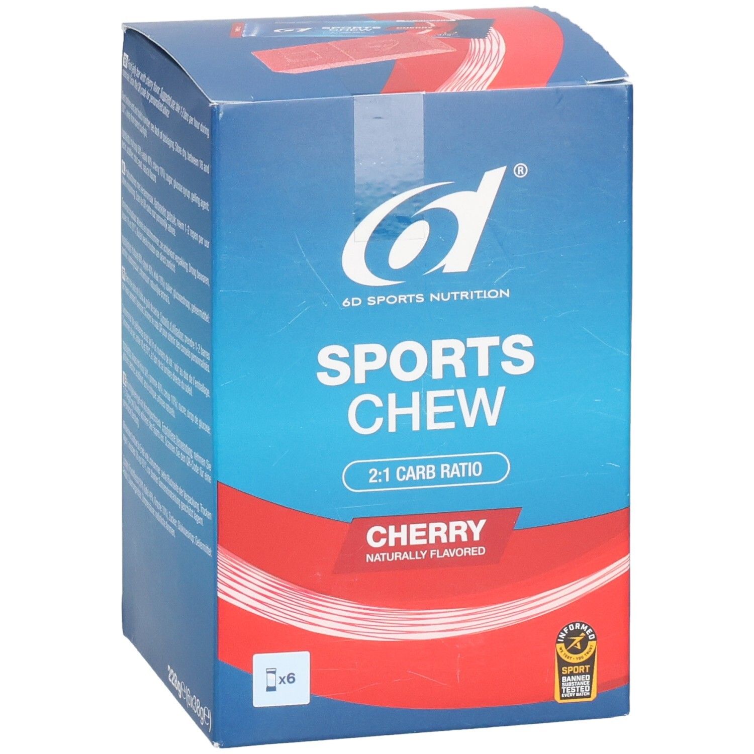 Vue en biais de la boîte en carton. Inscription: 6D SPORTS NUTRITION, SPORTS CHEW, 2:1 CARB RATIO, CHERRY. Avec 6 x. Sceau.