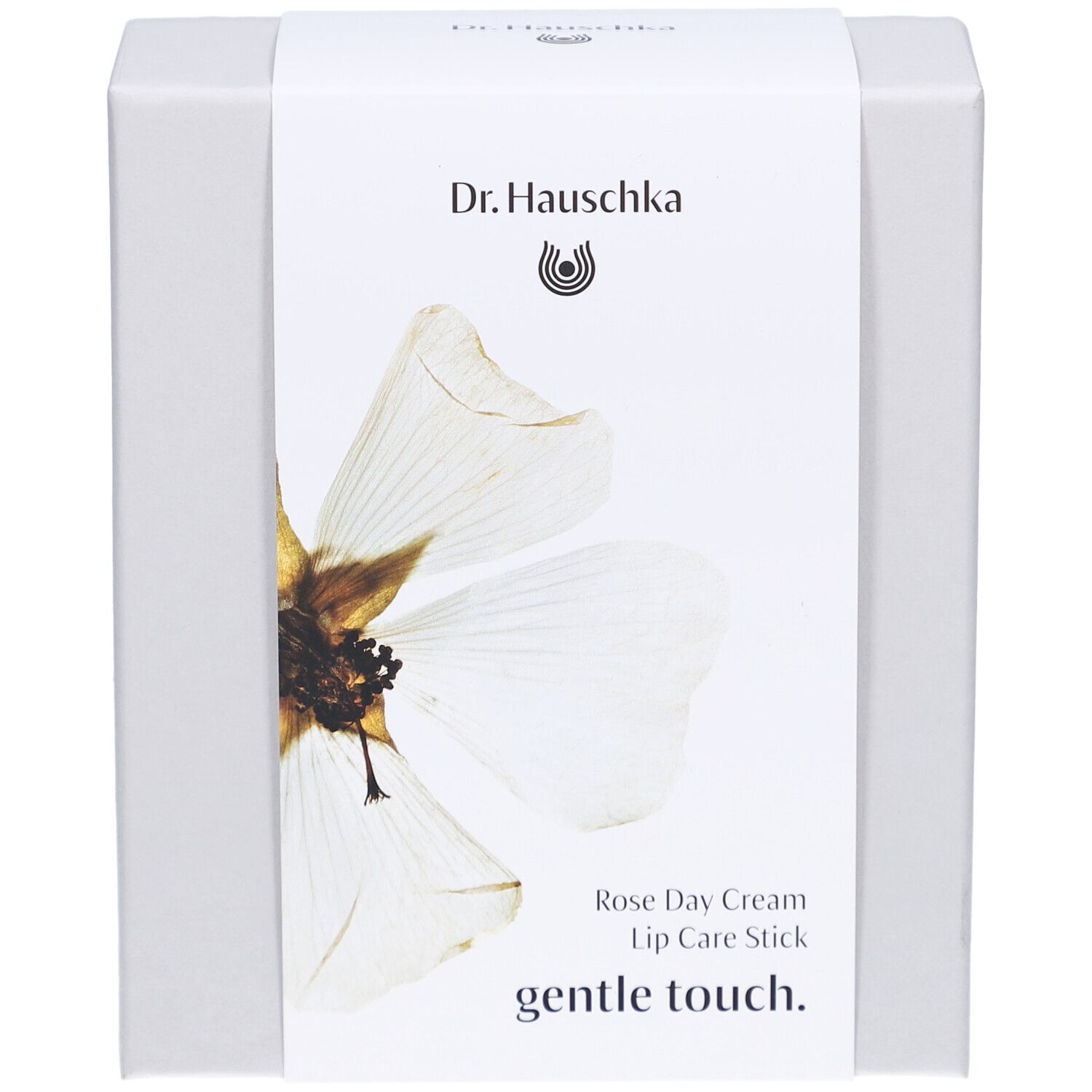 Boîte blanche avec étiquette. Inscription: Dr. Hauschka, Rose Day Cream, Lip Care Stick, gentle touch.