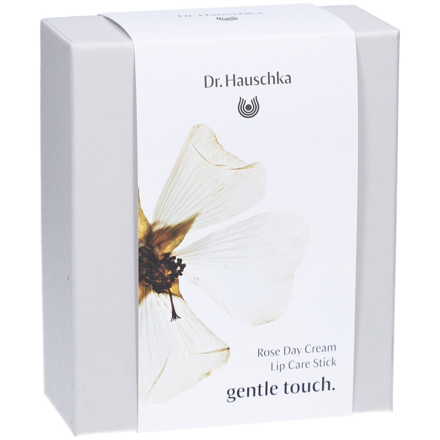 Boîte blanche avec étiquette. Inscription: Dr. Hauschka, Rose Day Cream, Lip Care Stick, gentle touch.