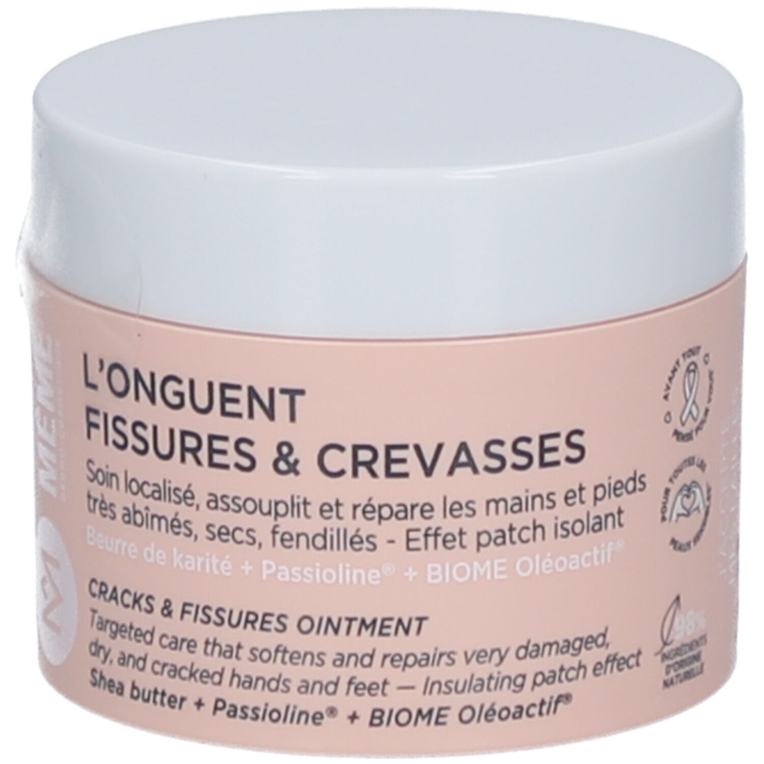 Pot de crème, couvercle blanc. Inscription: L'ONGUENT FISSURES & CREVASSES. Étiquette rose avec informations produit.