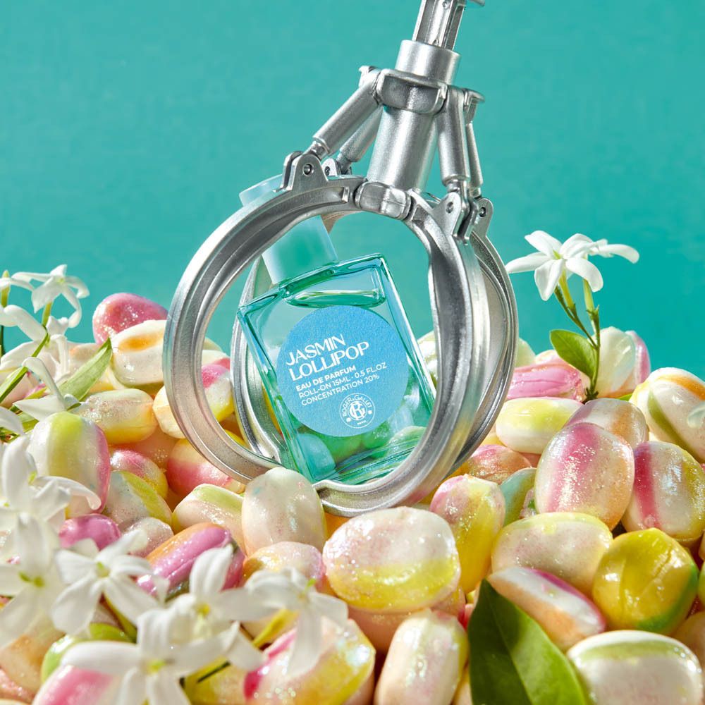 Emballage fin pour Jasmin Lollipop Eau de Parfum. Turquoise avec motif floral rose et logo.