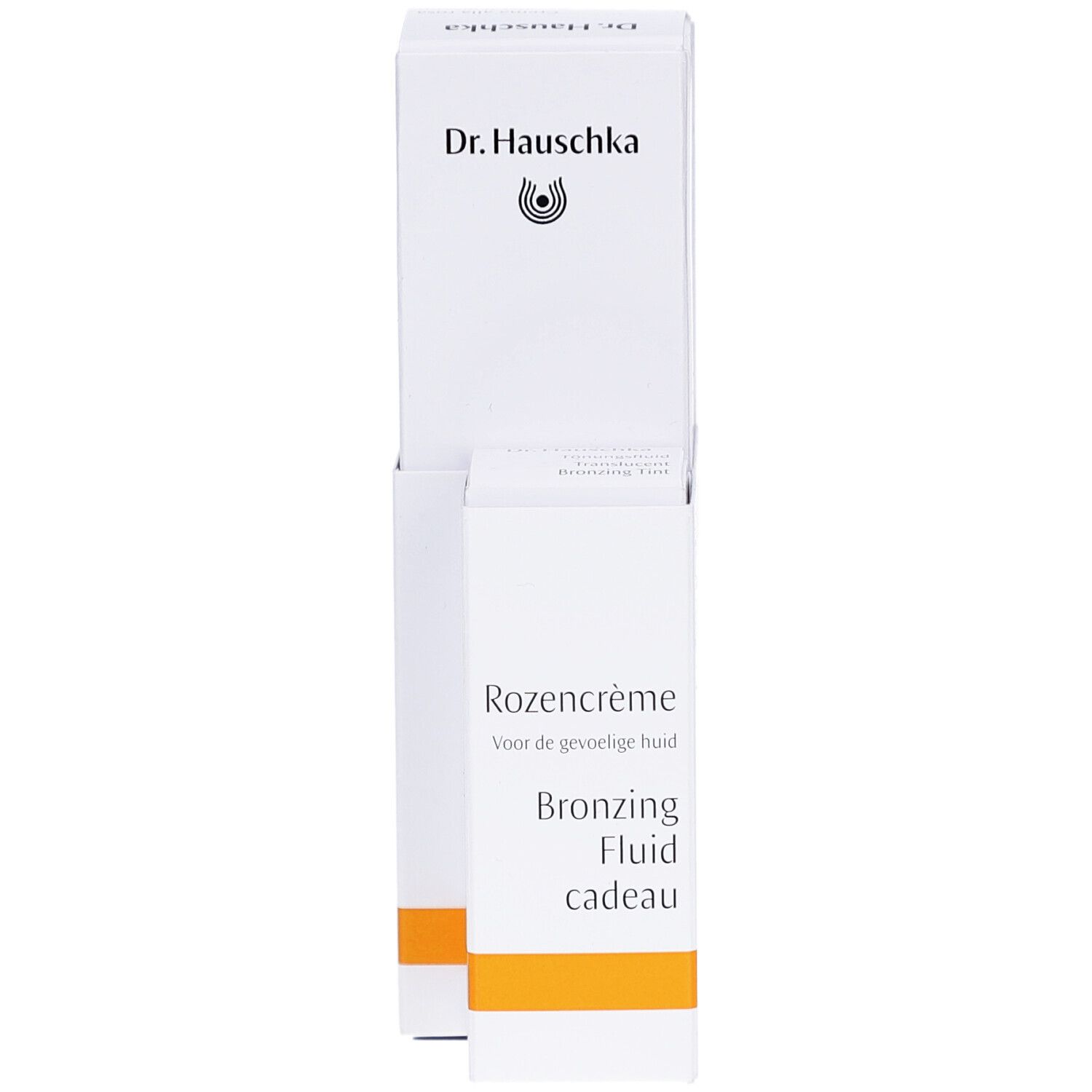Emballage blanc Dr. Hauschka. Texte: Rozencrème, Bronzing Fluid cadeau. Bande orange.
