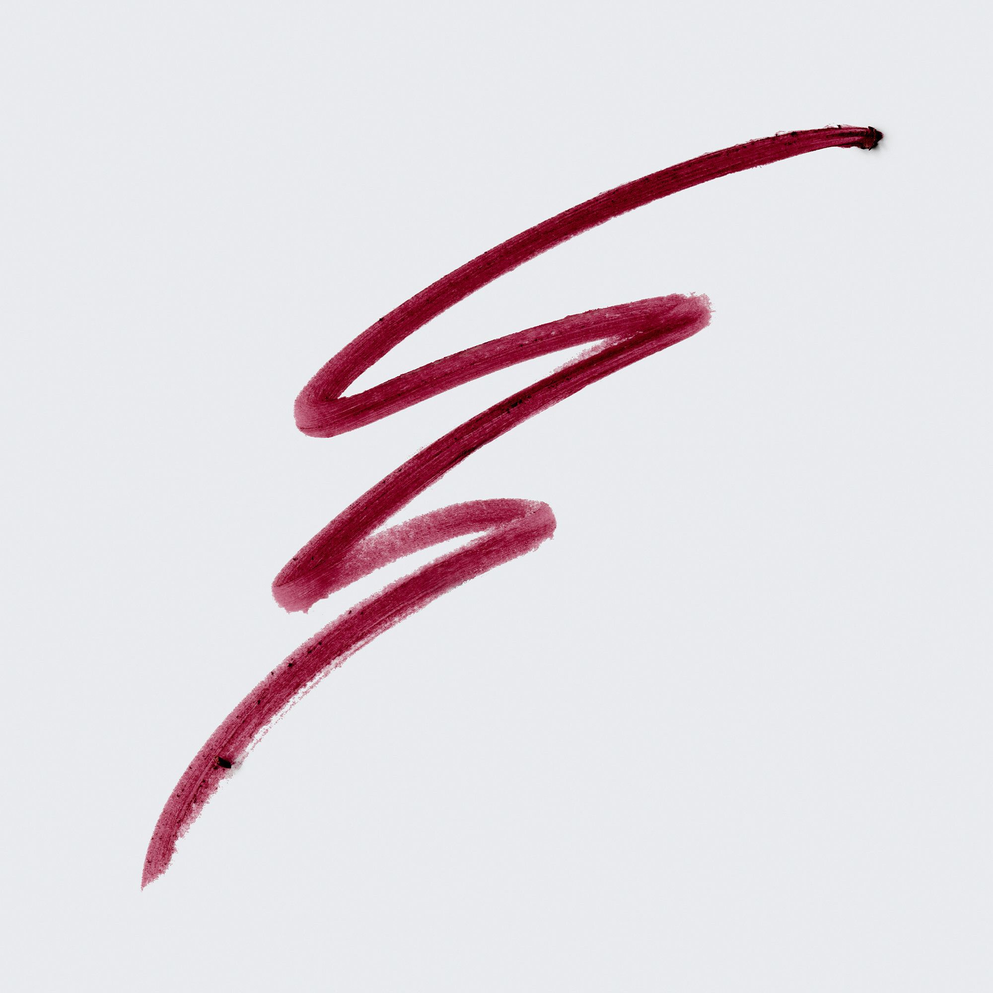 Trace de crayon contour des lèvres marron sur fond blanc. La trace est en forme de vague.