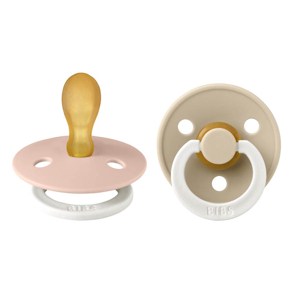 Deux sucettes BIBS. Rose et beige. Forme ronde. Tétine en silicone. Anneau blanc. Logo BIBS.