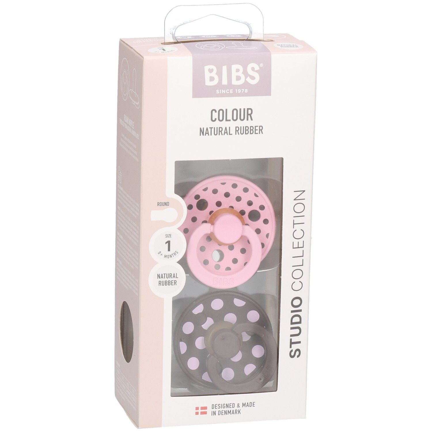 Emballage de deux sucettes. Rose et marron à pois blancs. Marque : BIBS. Fenêtre transparente.