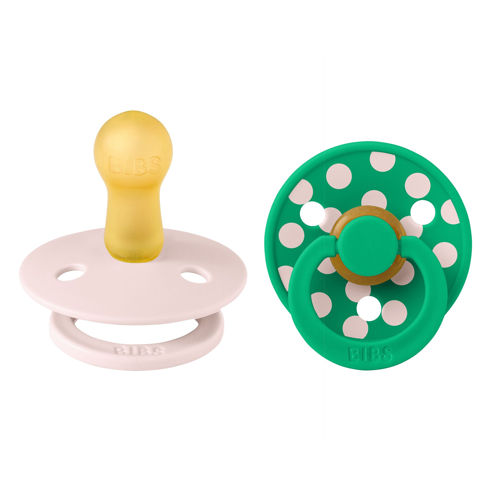 Deux sucettes : rose et verte à pois blancs. Tétine jaune. Marque : BIBS. Caoutchouc naturel.