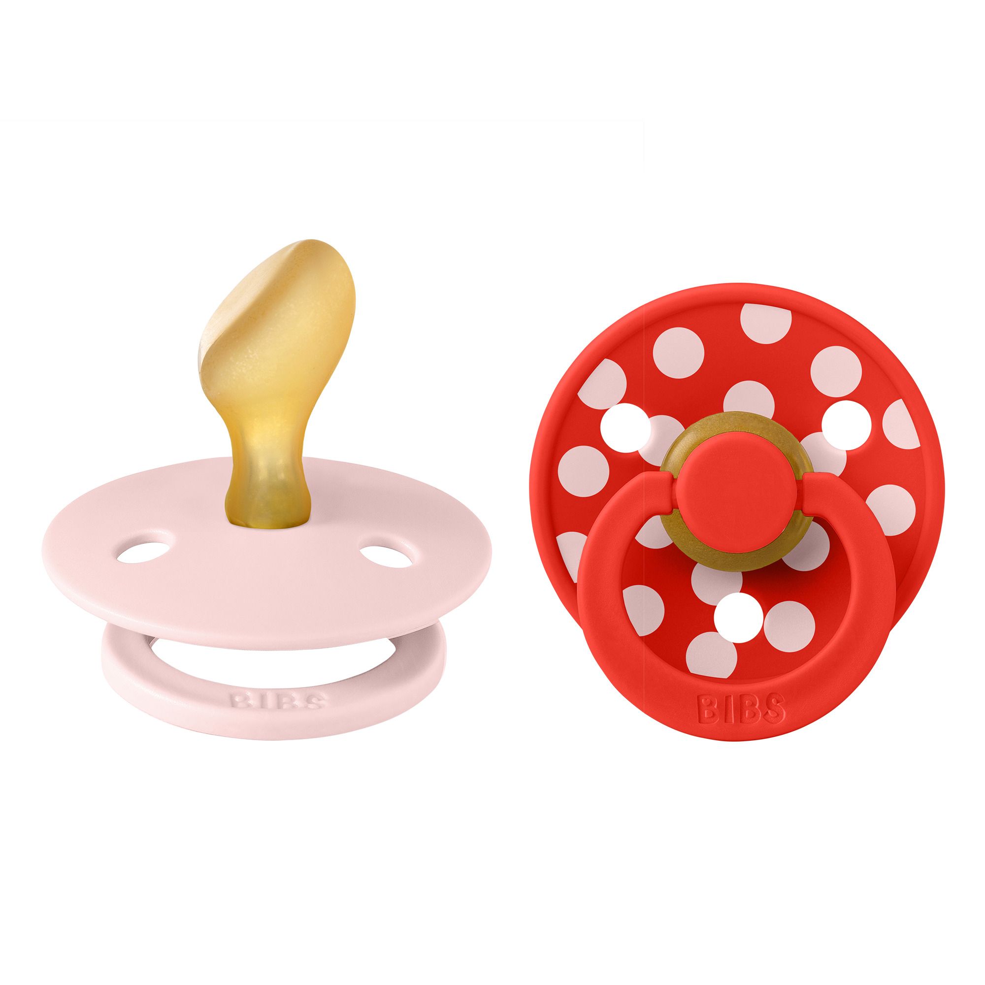 Deux sucettes. Rose et rouge à pois blancs. Logo BIBS sur la sucette rouge. Forme anatomique.