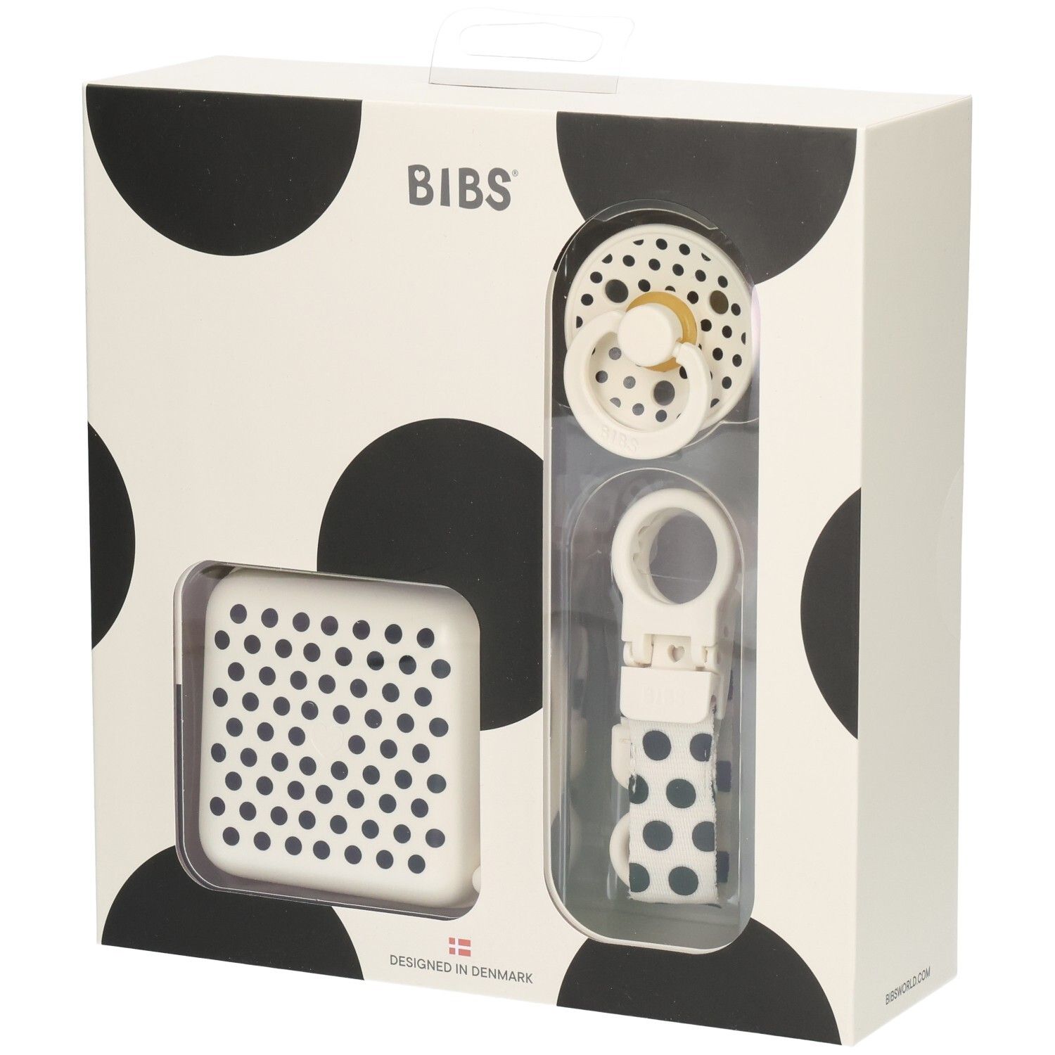 Coffret cadeau avec sucette, boîte et attache-sucette. Emballage à pois noirs. Marque BIBS.