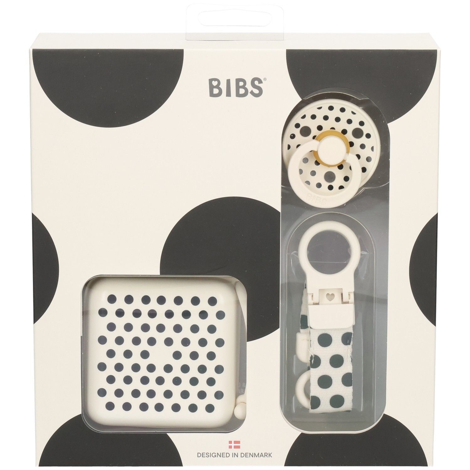Coffret cadeau avec sucette, boîte et attache-sucette. Emballage à pois noirs. Marque BIBS.