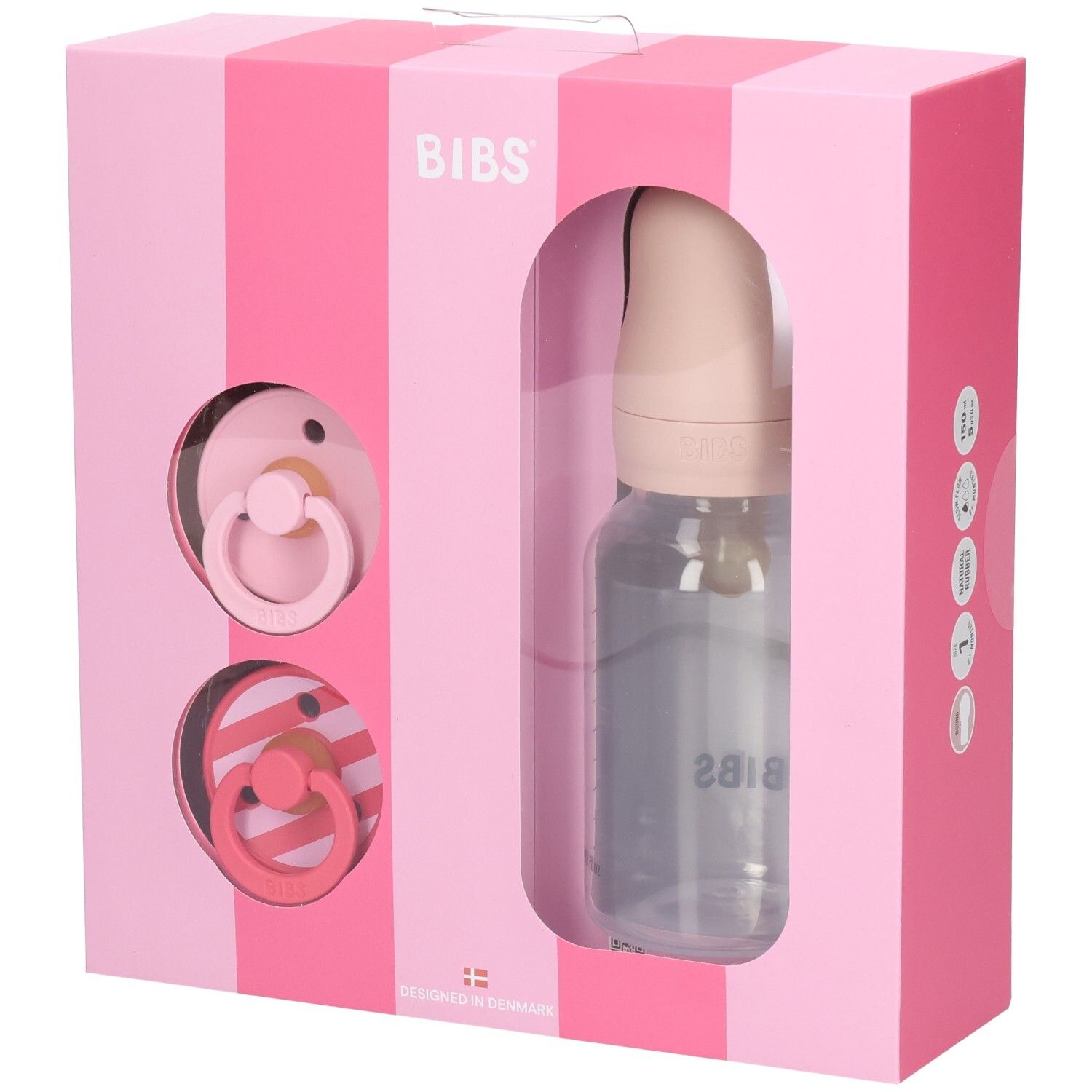 Coffret rose avec sucettes et biberon. Logo BIBS. Biberon transparent avec graduation. Deux sucettes.