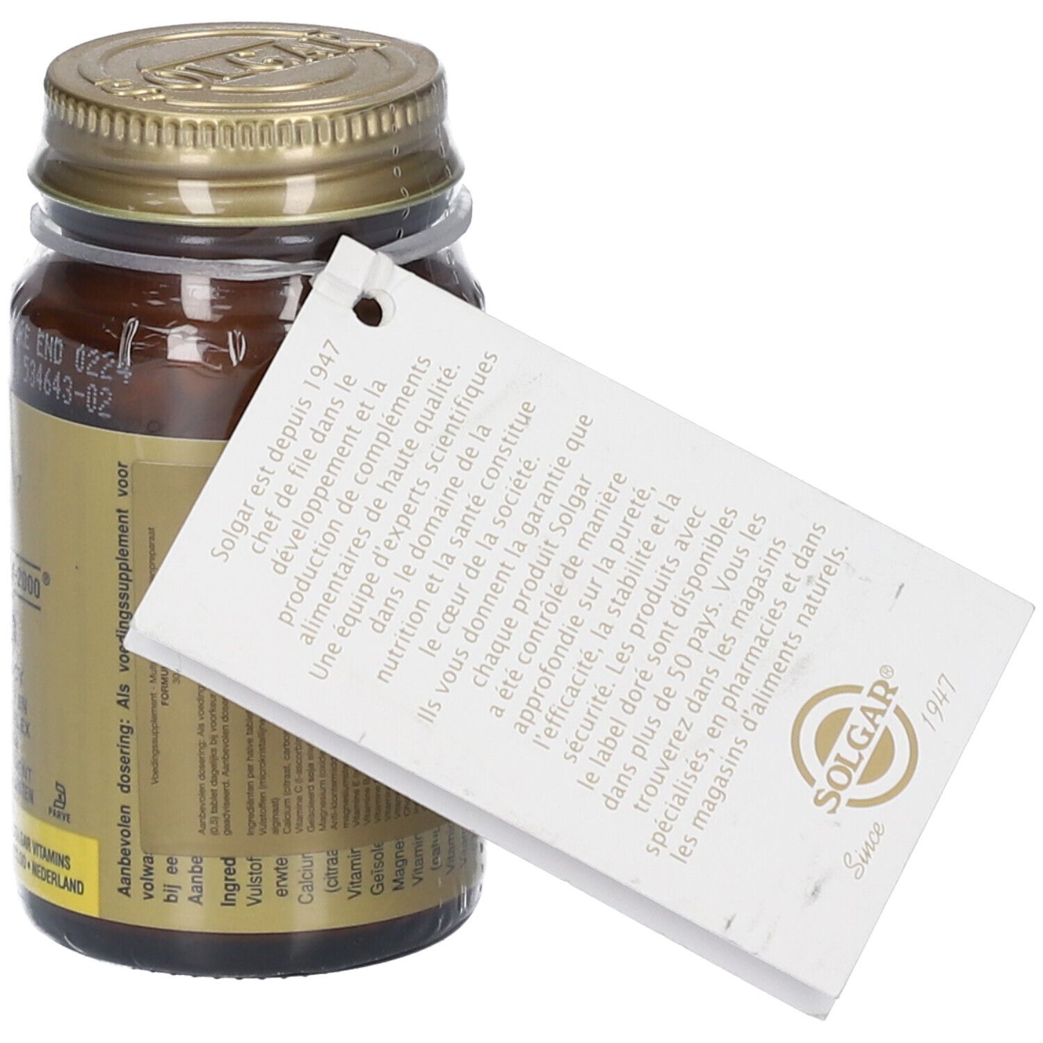 Flacon en verre brun avec couvercle doré. Étiquette avec texte et logo. Emballage plastique transparent.