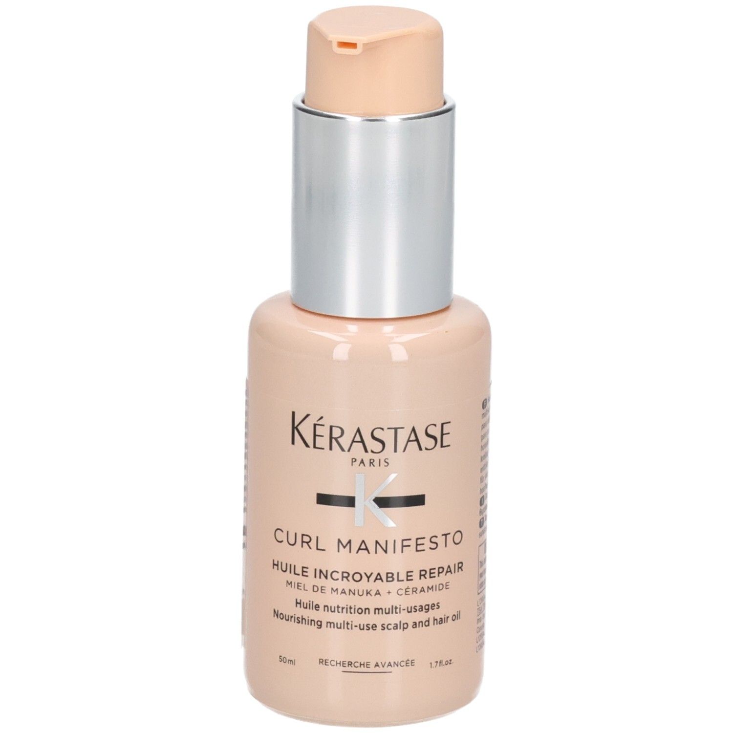 Huile multi-usages Kérastase Curl Manifesto dans un flacon pêche avec pompe. Contient du miel de Manuka et des céramides.