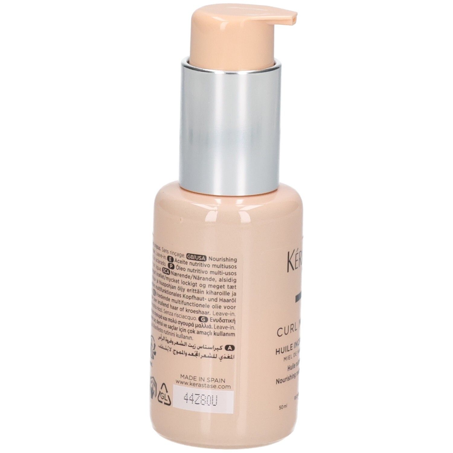 Flacon pompe beige avec col argenté et pompe beige clair. Étiquette avec informations produit et 'KÉRASTASE'.