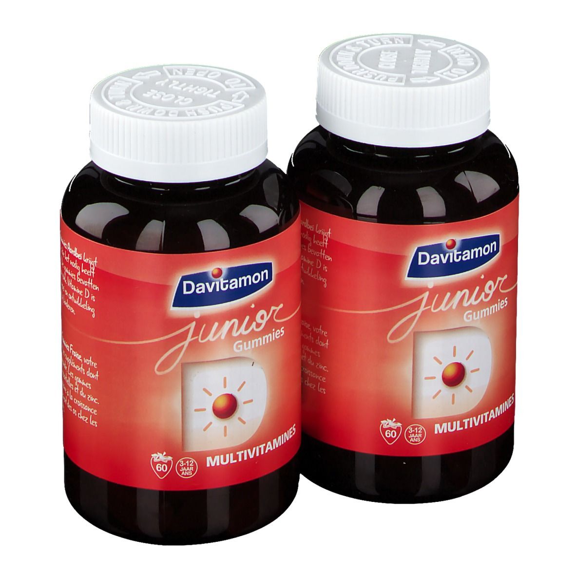 Deux flacons de Davitamon Junior Gummies. Étiquettes rouges, couvercles blancs. Inscription : Junior Gummies, Multivitamines.