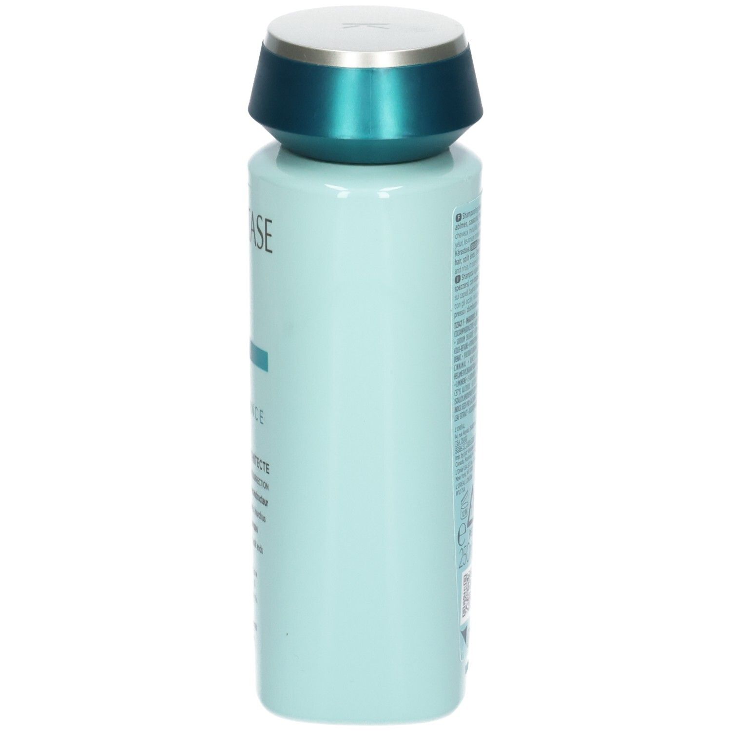 Vue latérale de la bouteille de shampooing Kérastase bleu clair avec bouchon turquoise.