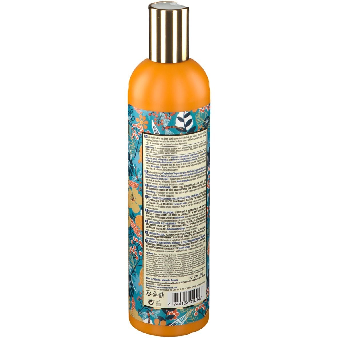 Dos du flacon orange. Texte en plusieurs langues. Motif floral.