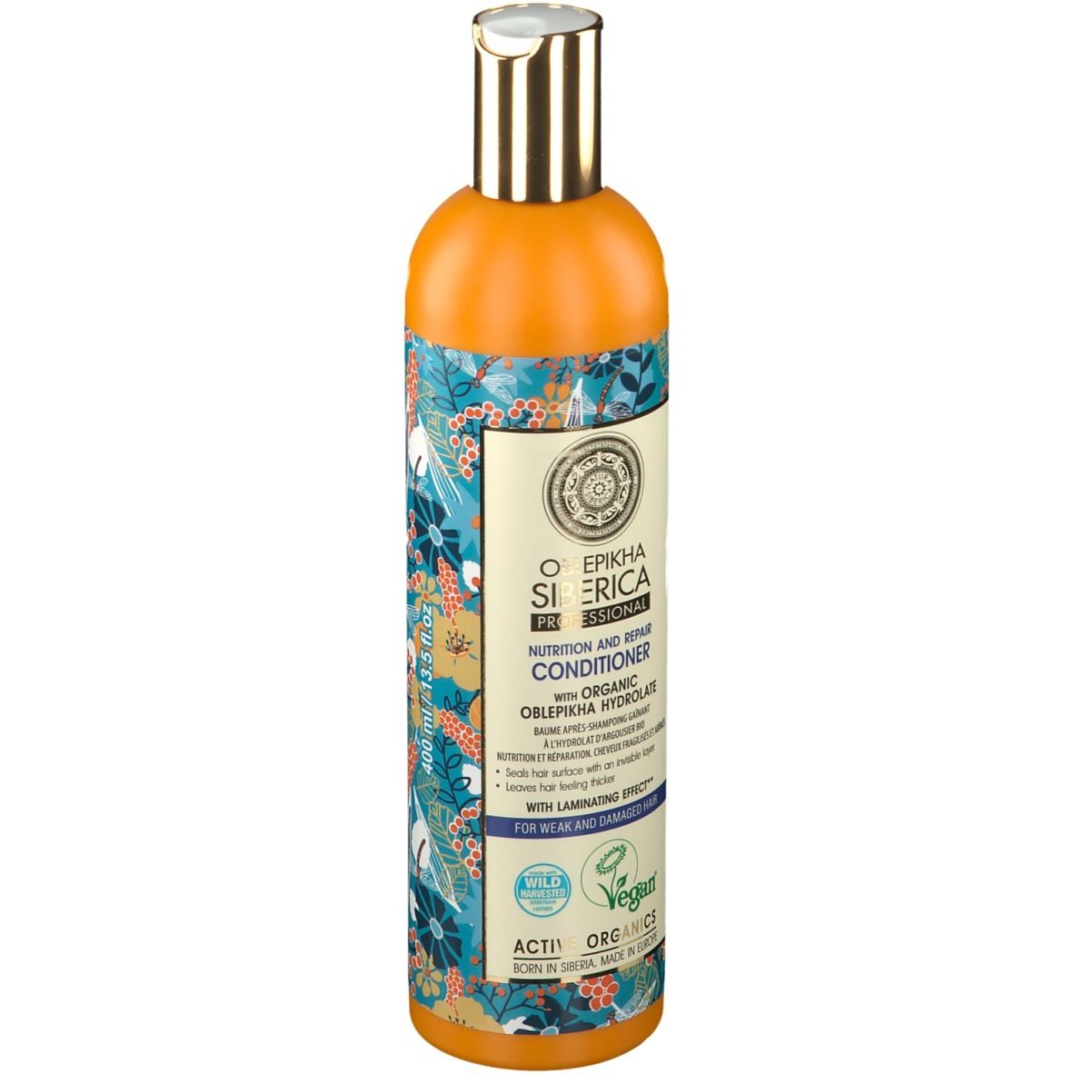 Flacon orange avec motif floral. Étiquette avec informations produit et logo. Label vegan.