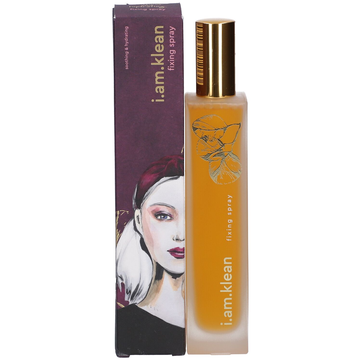 Flacon avec vaporisateur doré et emballage en carton. Inscription : i.am.klean, fixing spray. Visage de femme sur l'emballage.