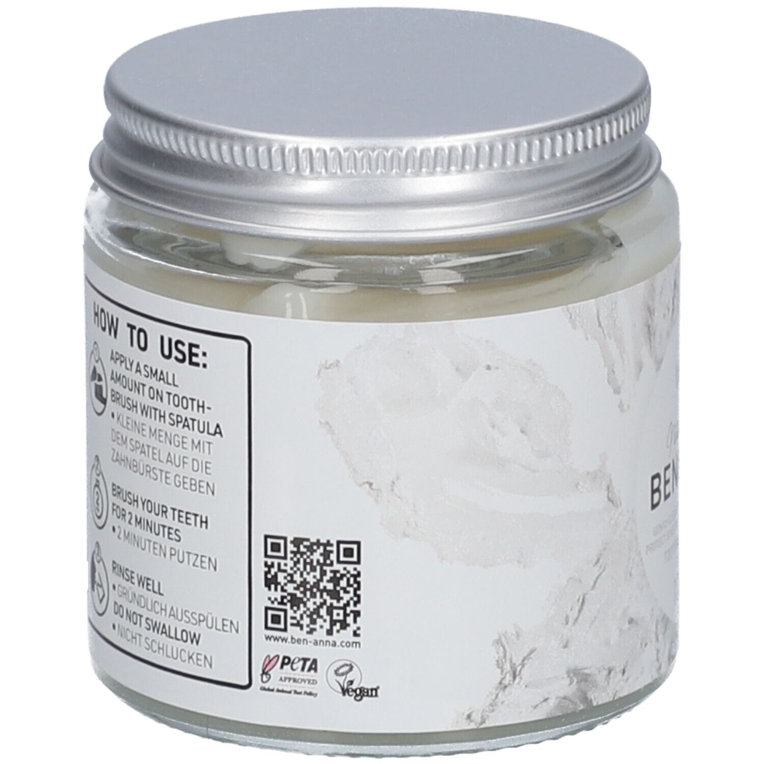 Dos du pot de dentifrice. Étiquette avec instructions d'utilisation, code QR et certifications.