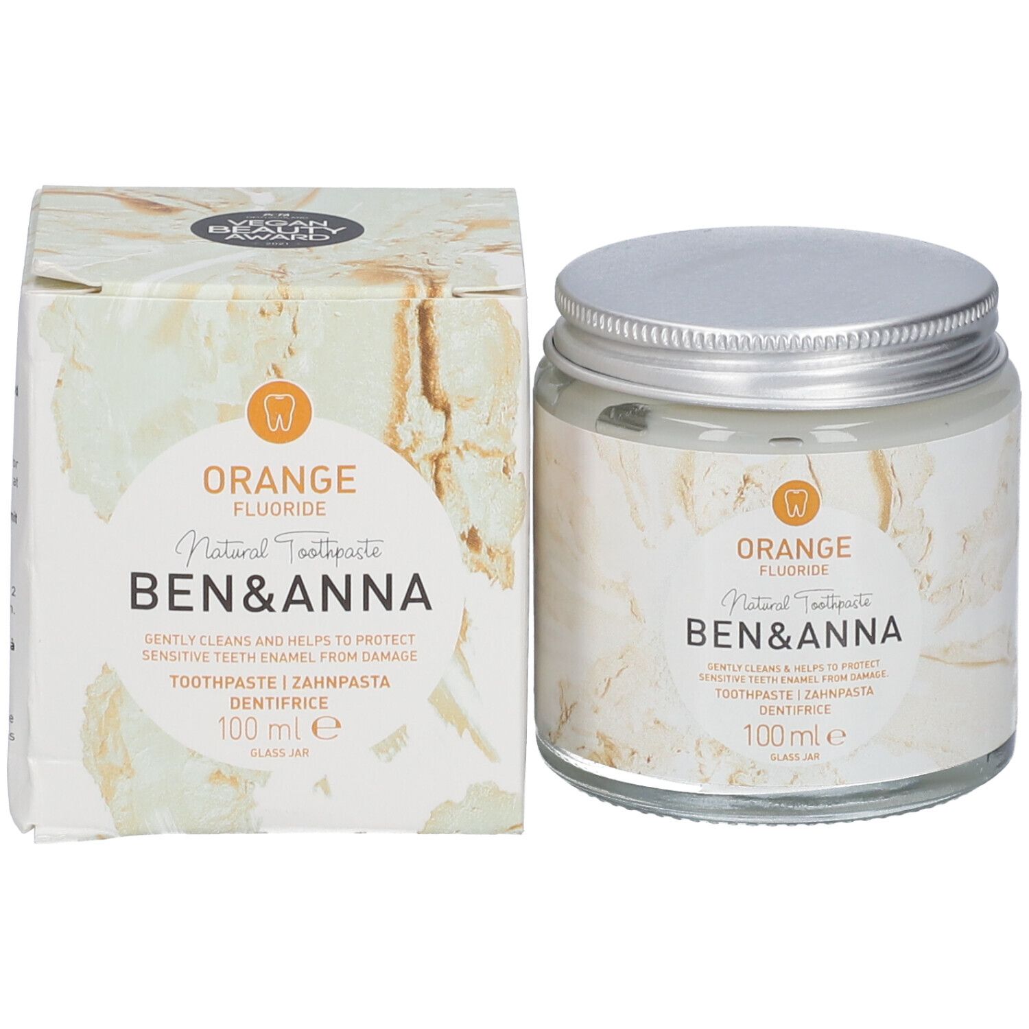 Pot de dentifrice en verre et emballage. Inscription Orange, Fluoride, Ben & Anna, dentifrice, 100 ml. Couvercle argenté.