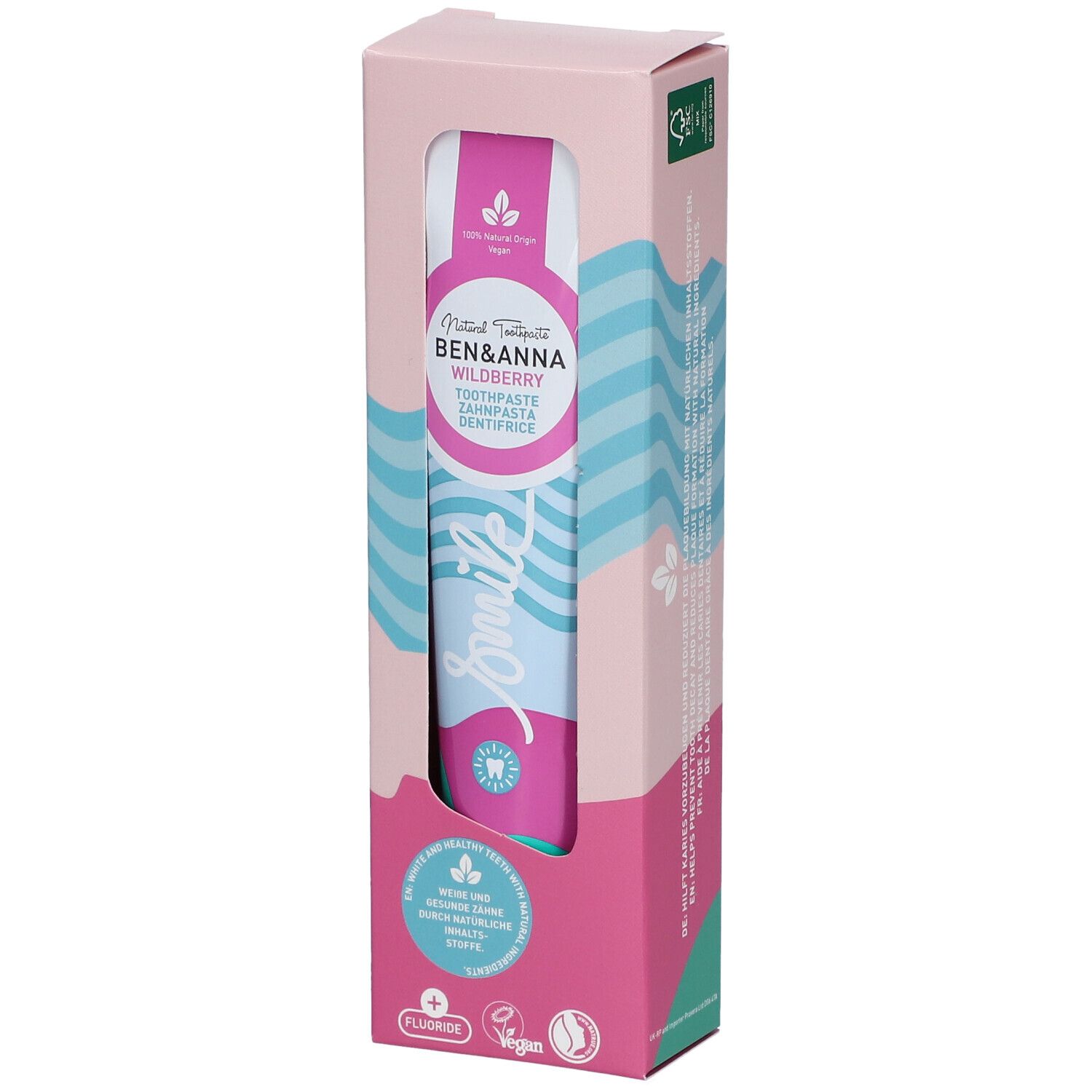 Dentifrice dans son emballage. Design rose et blanc avec nom et logo du produit. Tube visible avec motif vagues bleu et rose.