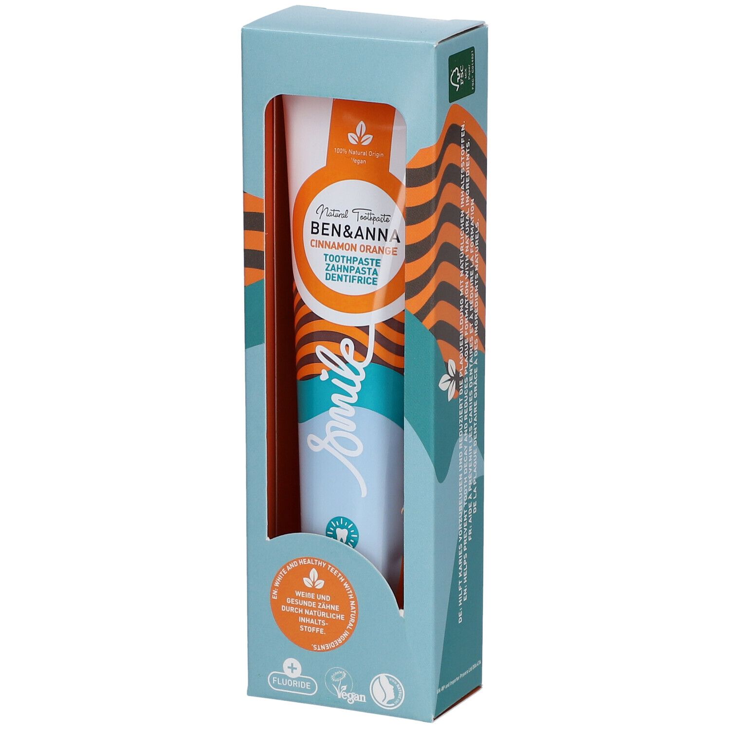 Dentifrice en boîte. Marque Ben & Anna, saveur Cinnamon Orange. Visible: tube, inscription 'smile', symbole fluor.