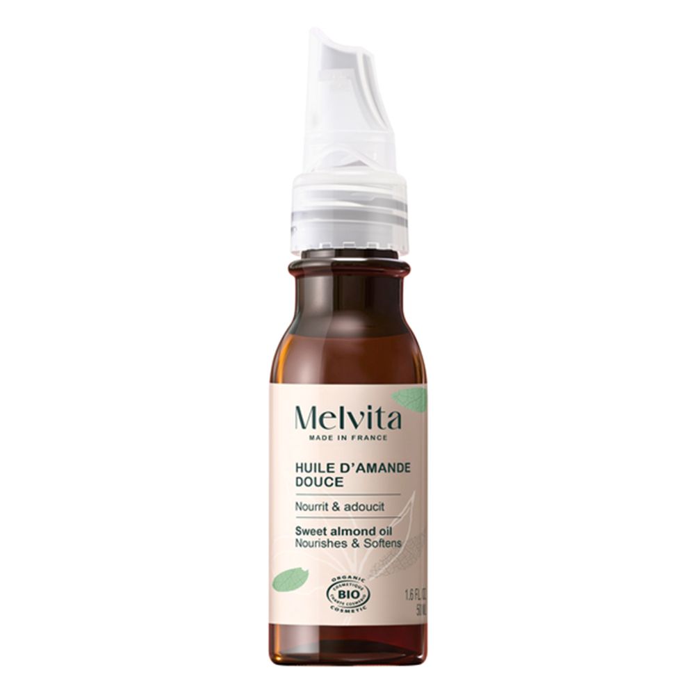 Flacon en verre brun avec applicateur. Inscription: Melvita Huile d'Amande Douce, certification BIO.
