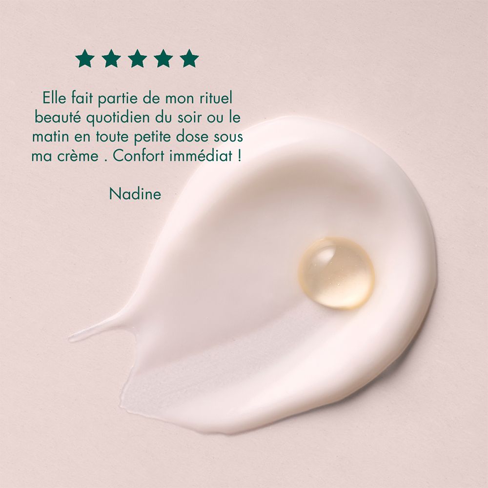 Produit appliqué sur de la crème. Texte: Nadine. Citation et étoiles.
