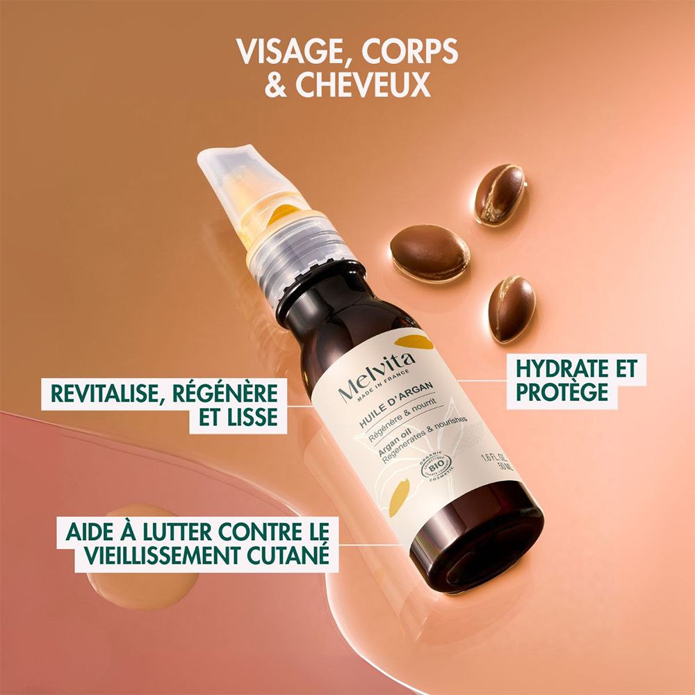 Flacon d'huile d'argan Melvita avec applicateur, vue de côté. "Pour le visage, le corps et les cheveux".