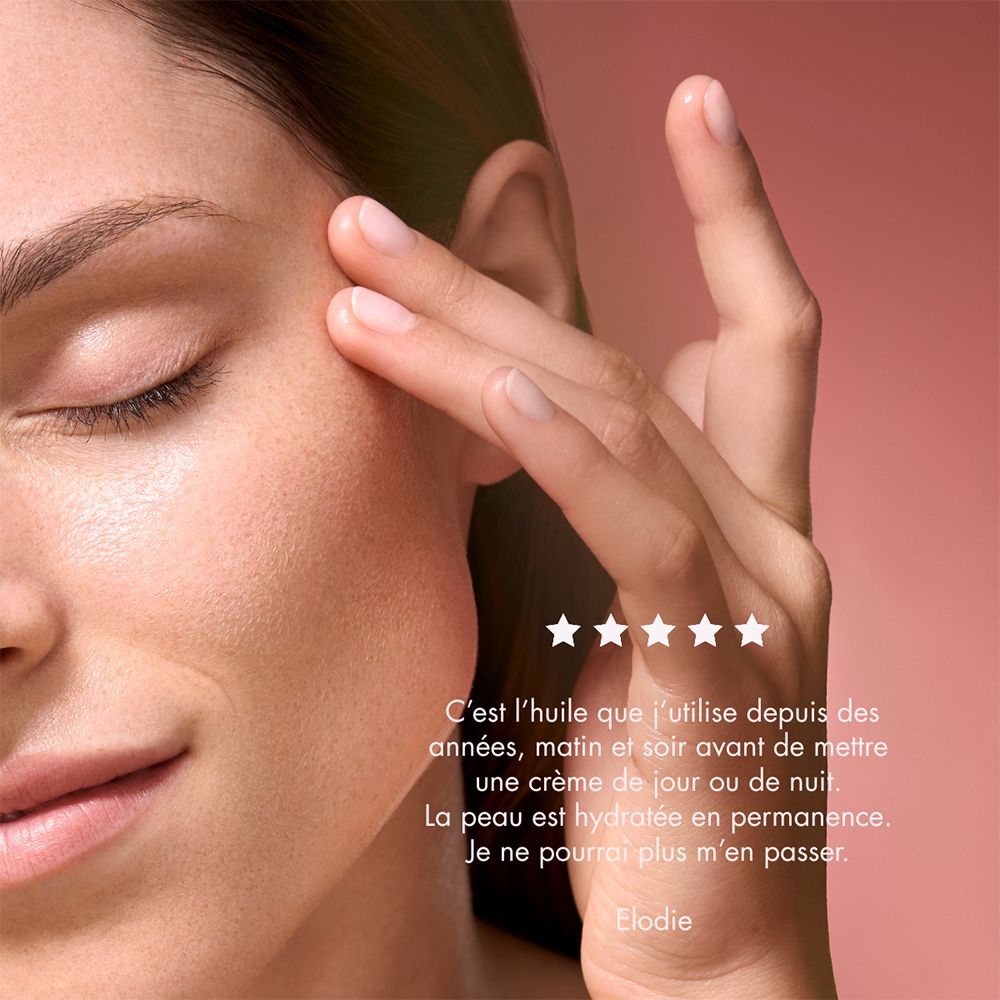 Flacon d'huile d'argan Melvita avec applicateur, vue de côté. "Pour une peau plus lisse".