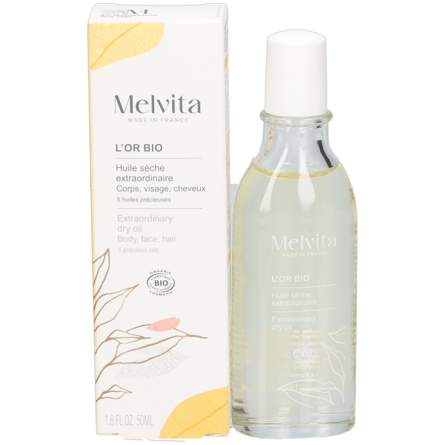 Flacon Melvita d'huile claire et sa boîte avec motif de feuilles.