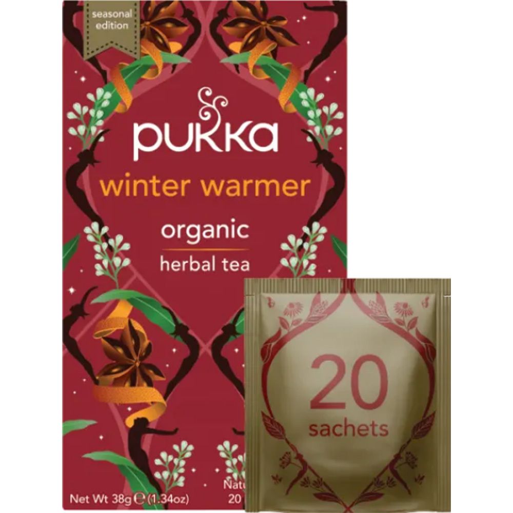 Boîte de thé Pukka Winter Warmer et sachet individuel. Emballage rouge avec motif floral et informations sur le produit.
