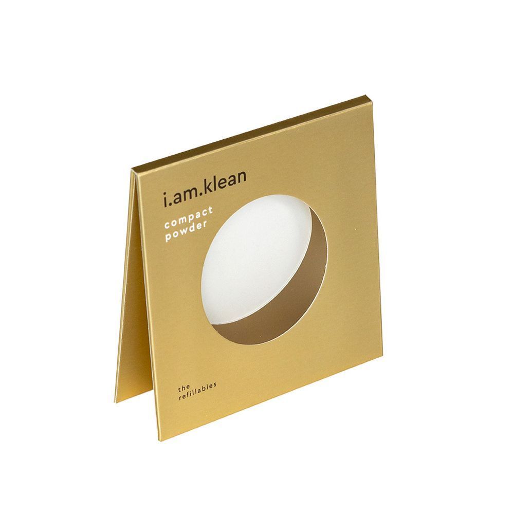 Emballage doré avec fenêtre ronde. Inscription i.am.klean et compact powder.