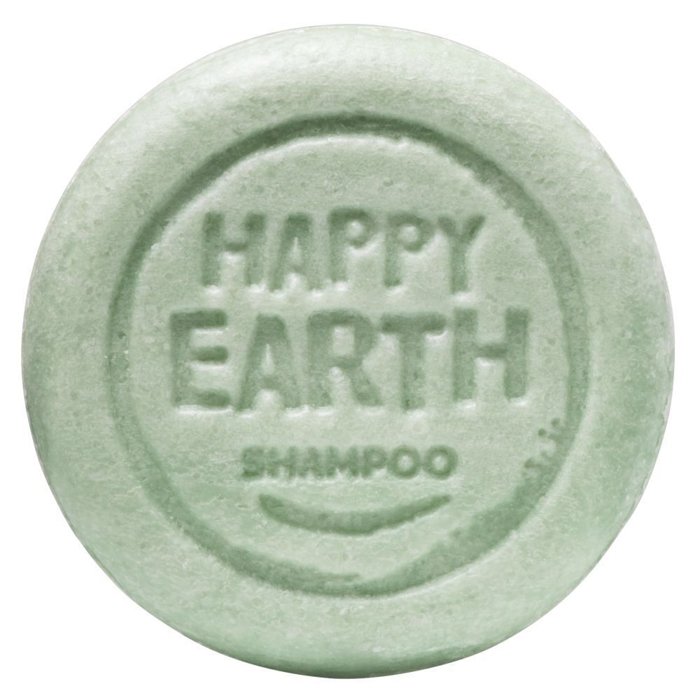 Pain de douche vert rond. Inscription: HAPPY EARTH SHAMPOO.