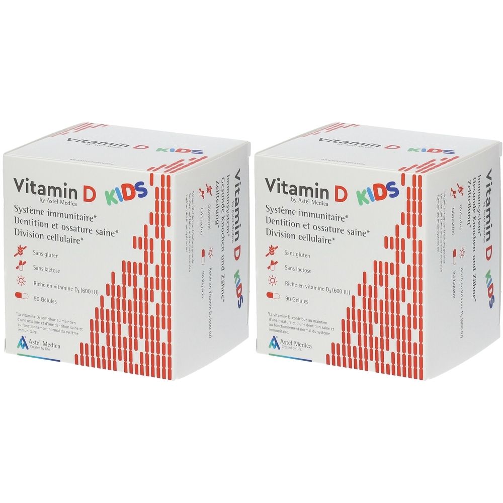 Deux boîtes blanches avec motif rouge et texte: Vitamin D KIDS. Contient 90 gélules. Système immunitaire, Dentition et ossature saine, Division cellulaire.