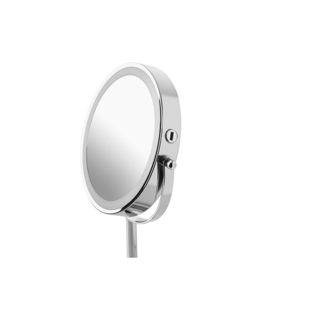 Gros plan du miroir cosmétique. Argenté, rond, avec éclairage LED. Panneau tactile.