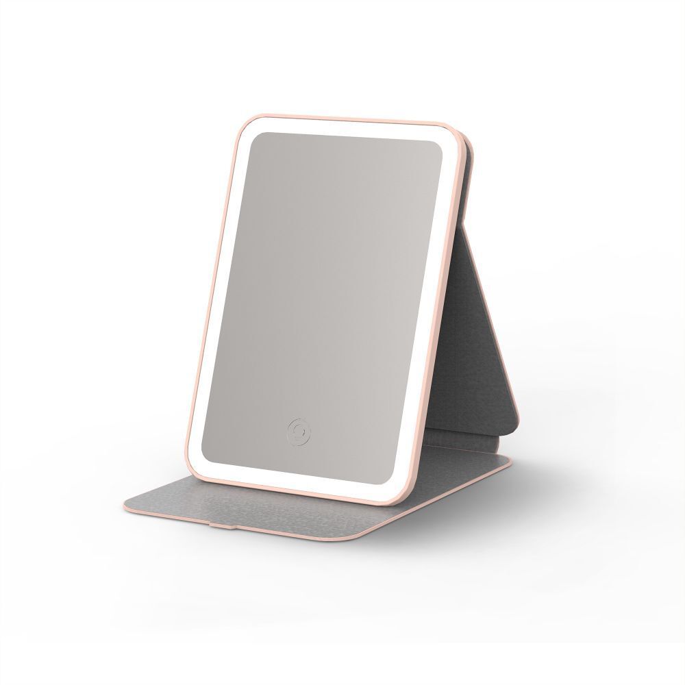 Miroir tablette LED, rose et blanc. Miroir rectangulaire avec éclairage LED. Pliable, avec support gris.