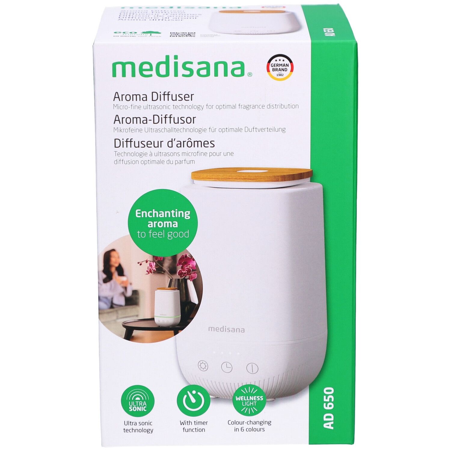 Diffuseur d'arômes en emballage. Blanc, couvercle bois, emballage vert. Marque : medisana. Nom : AD 650.