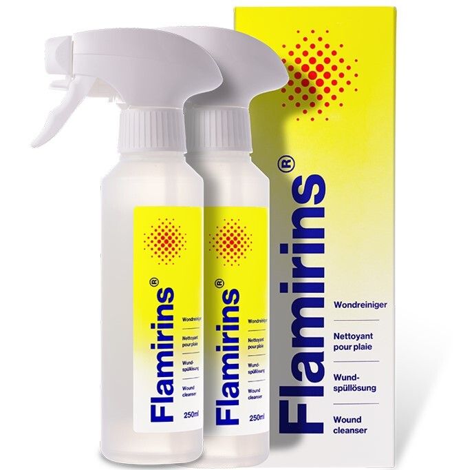 Deux flacons avec vaporisateur et étiquette jaune. Inscription Flamirins, nettoyant pour plaies. À côté, un emballage jaune avec motif de points rouges.