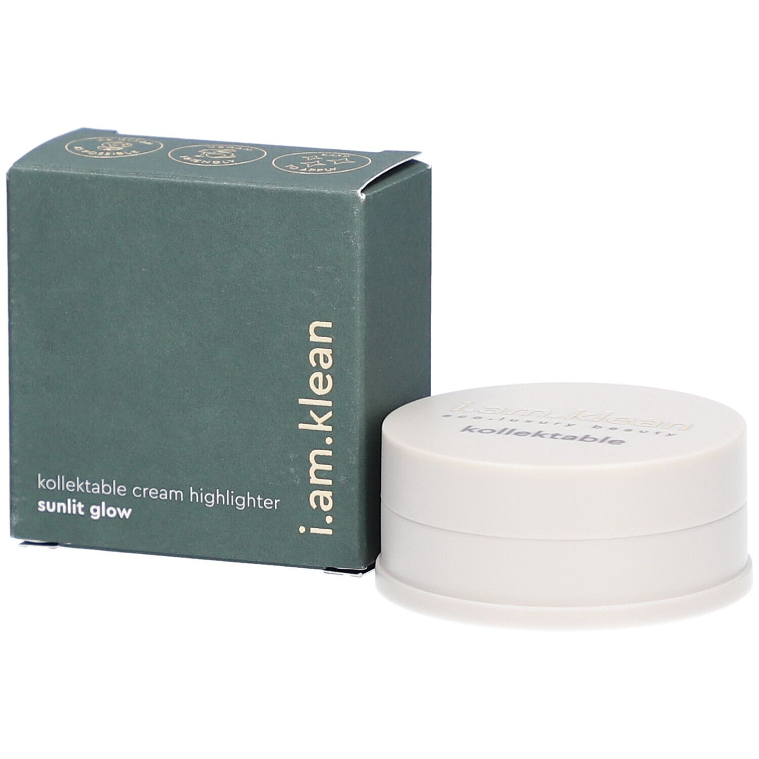 Boîte verte et contenant crème. La boîte porte i.am.klean, kollektable cream highlighter sunlit glow. Le contenant a un couvercle avec texte.