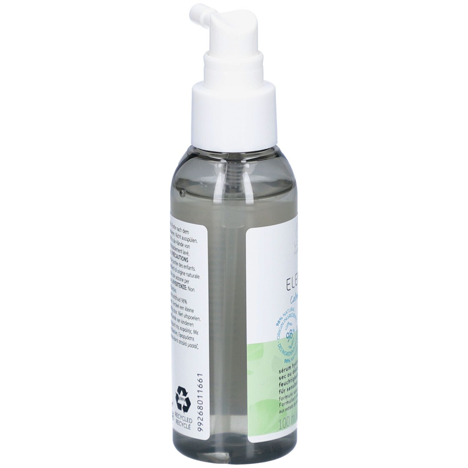 Dos d'un flacon transparent avec pompe blanche. Texte sur étiquette verte et blanche. Symbole de recyclage.
