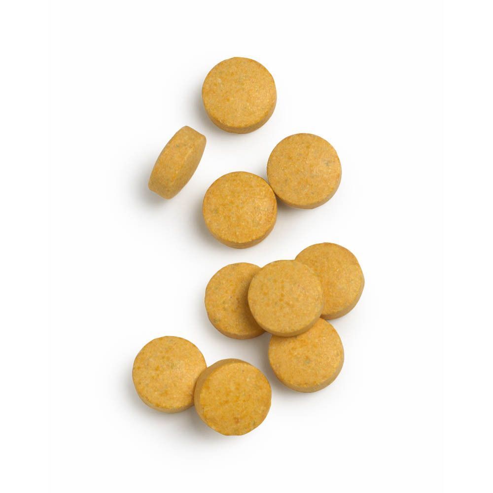 Un contenant blanc de B-Active Complex™ avec plusieurs comprimés à côté. Bouchon blanc.