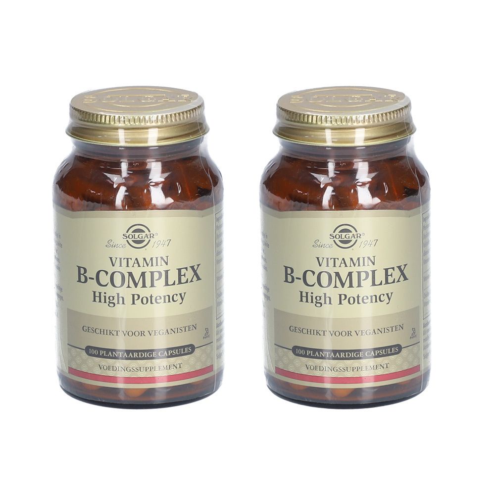 Deux flacons en verre brun avec couvercles dorés. Inscription : Vitamin B-Complex, High Potency. Convient aux végétaliens.
